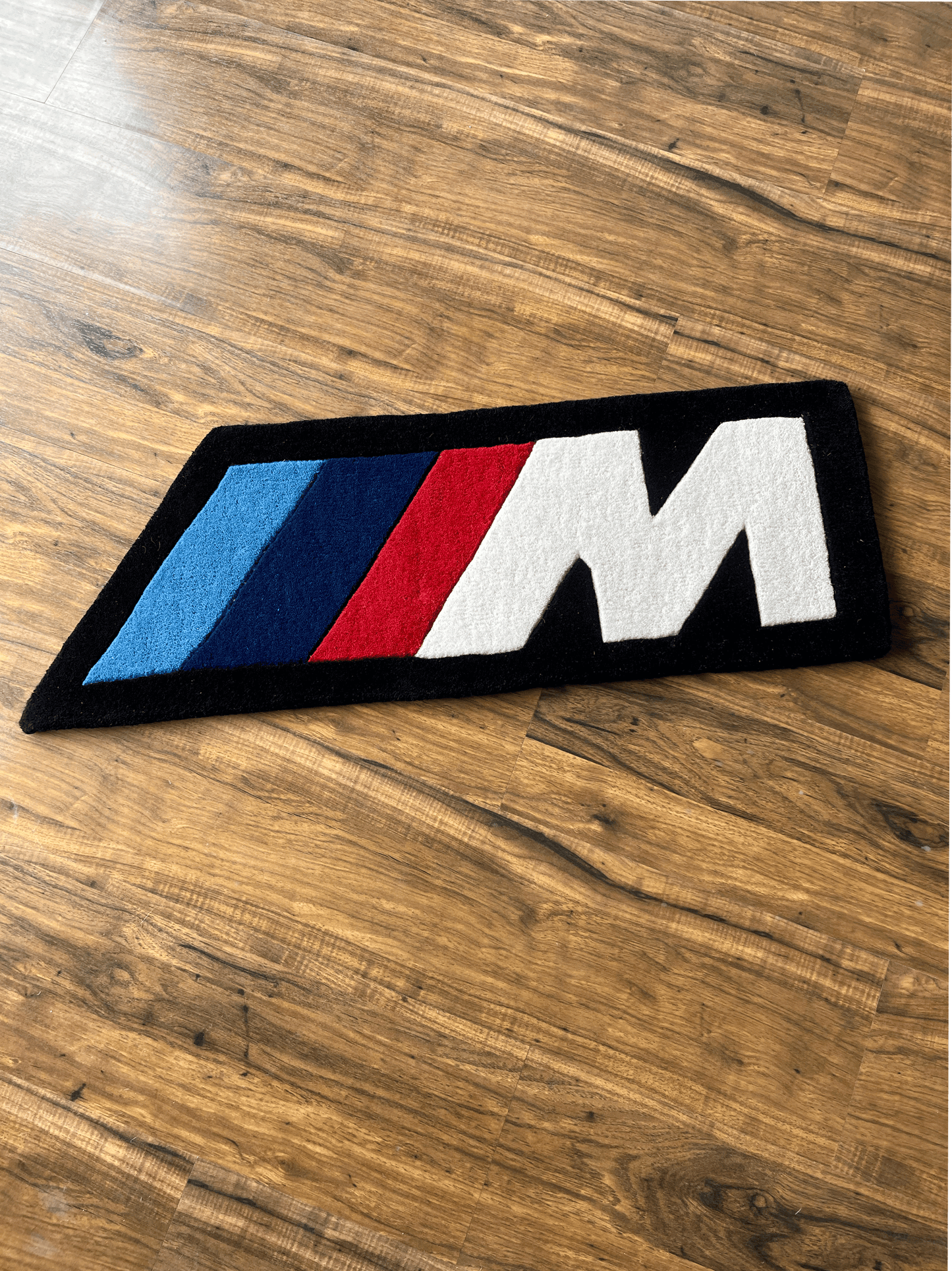M speed  racing Rug by The Drip Co.