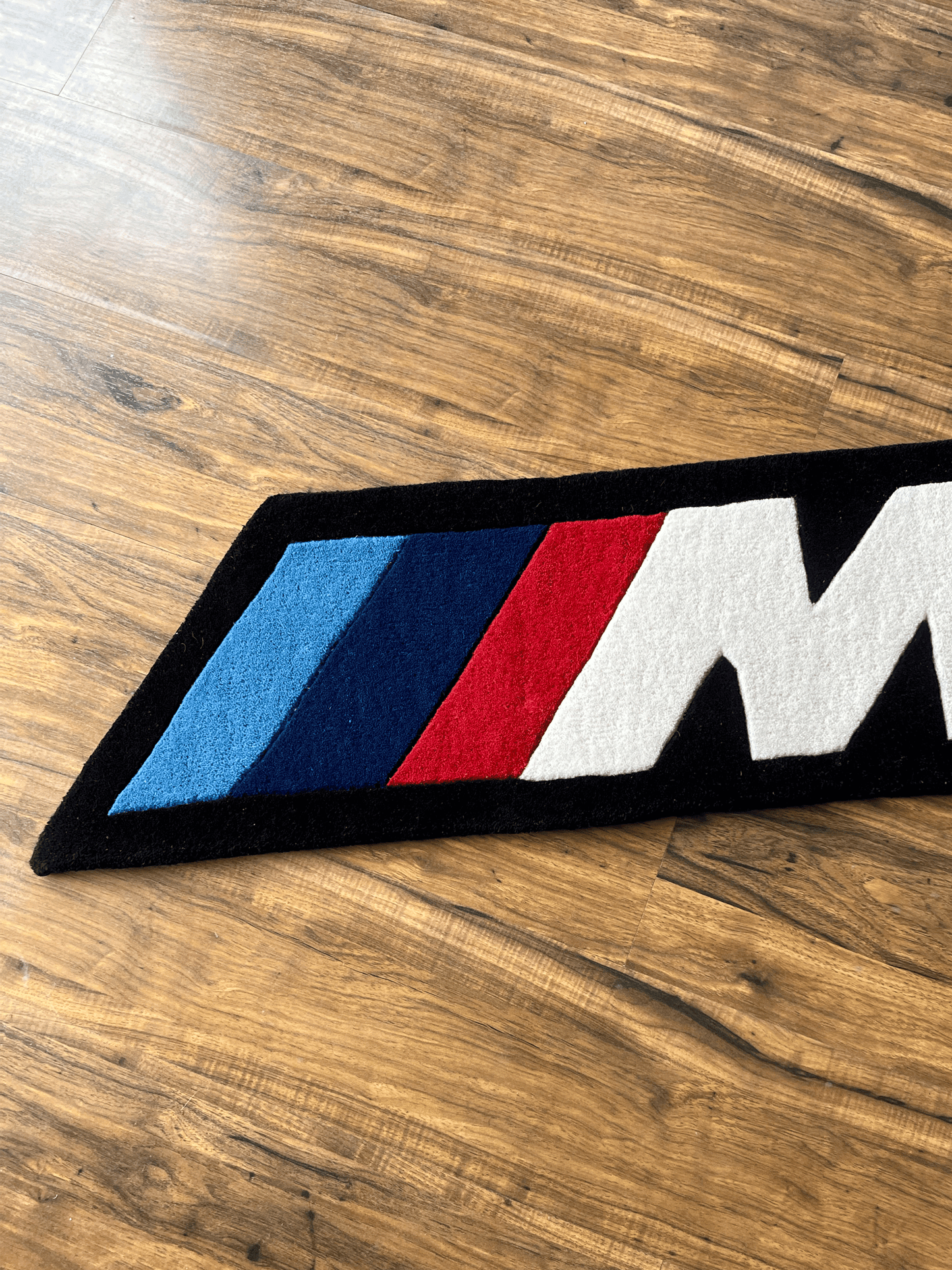 M speed  racing Rug by The Drip Co.