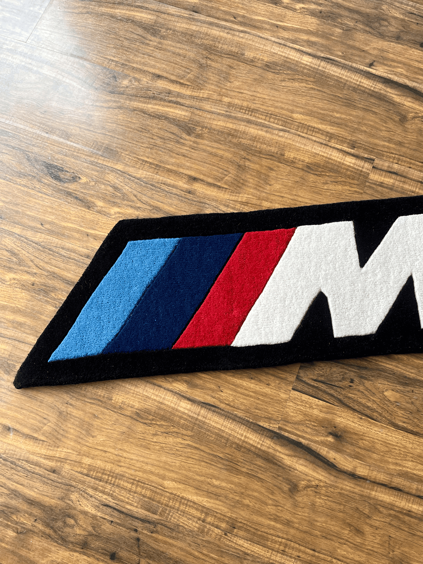 M speed  racing Rug by The Drip Co.