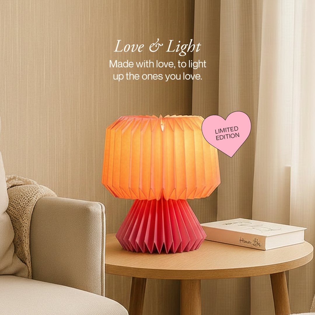Pink and orange lamp on a table with a heart-shaped 'Limited Edition' tag, in a living room setting.