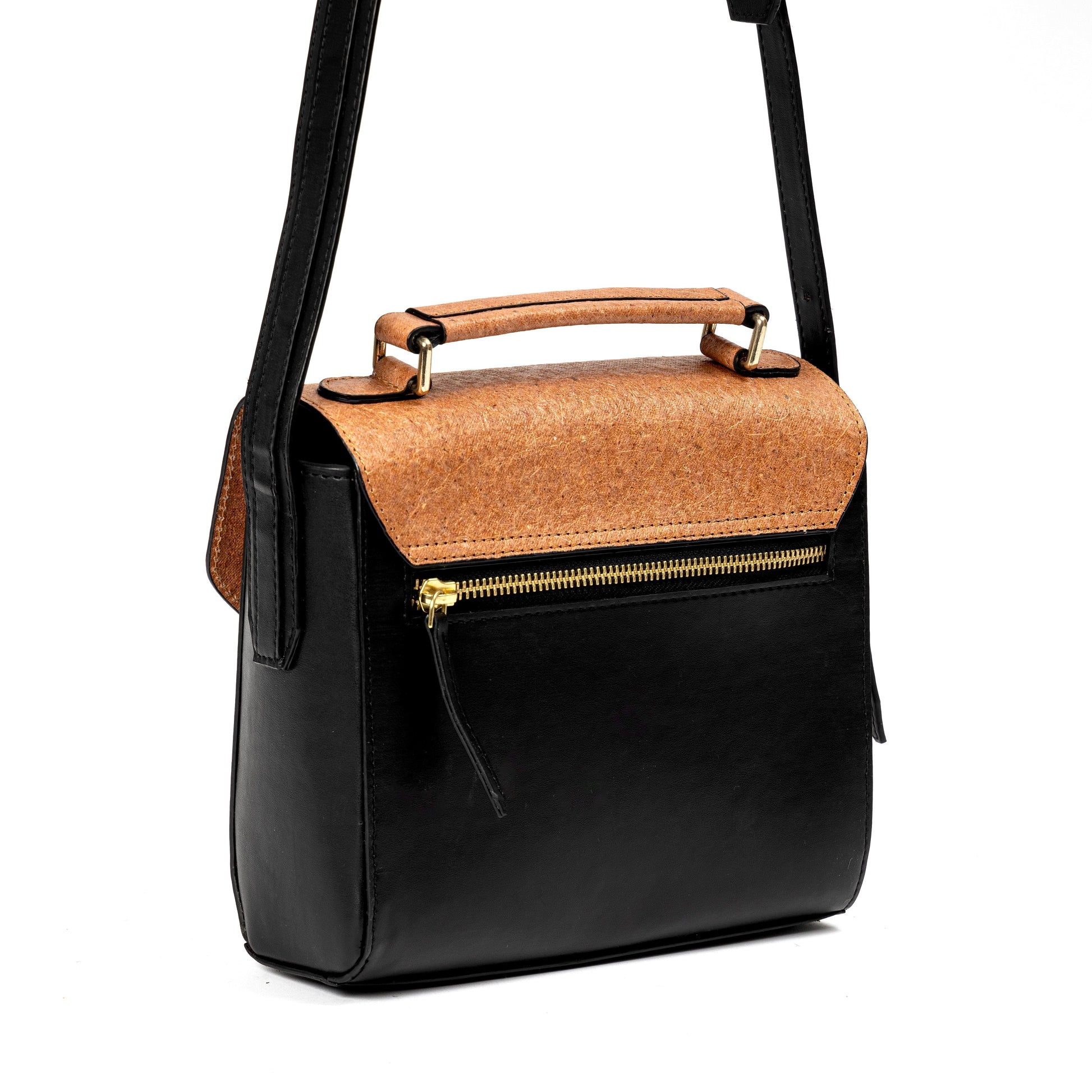 Back view of black and coconut orange plant leather sling bag with gold zipper pocket and top handle on a white background
