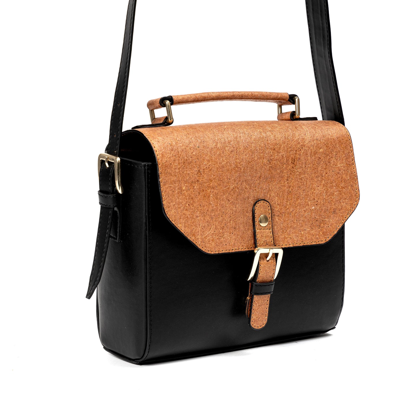 Black and coconut orange plant leather sling bag with flap and buckle closure on a white background with adjustable strap